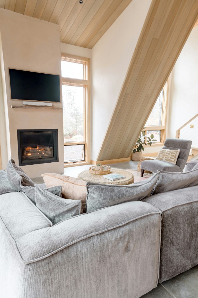Warm living room with fireplace and high ceilings